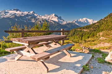 Picnic table and benches in Swiss Alps near mountain road. - 25467880