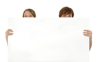 Two young women behind a blank banner ad