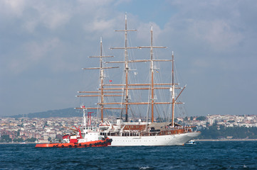 Tug Alongside Sailing Ship