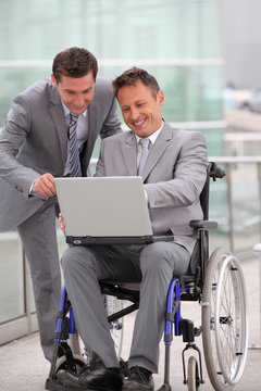 Man in wheelchair in business travel