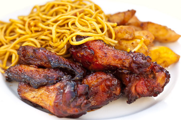 chicken wings and strips with chinese noodles isolated