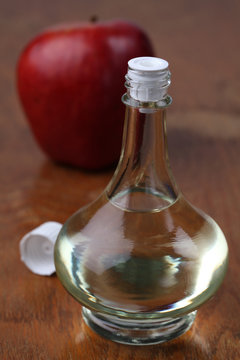 Bottle with apple vinegar and fresh apple. Shallow dof