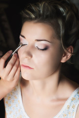 applying eye shadow with selective focus