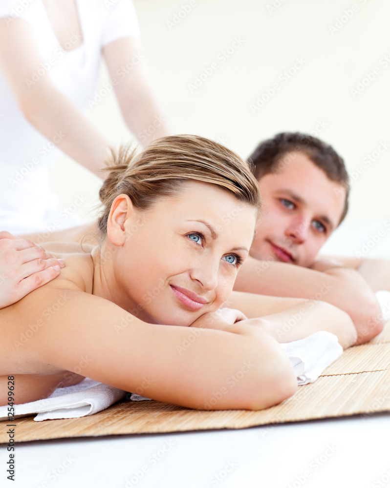 Wall mural Attractive young couple receiving a back massage