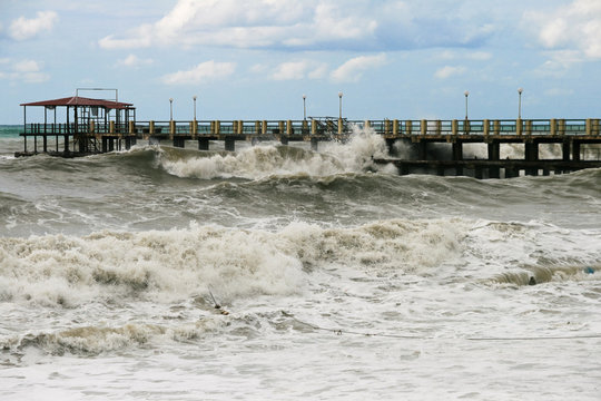 Storm at sea, waves on pier