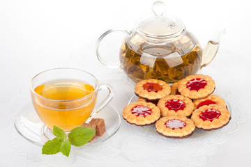 Cup of tea  with mint and pastries.