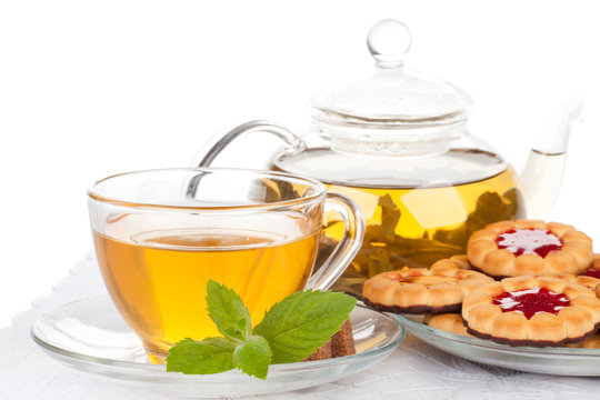 Cup of tea  with mint and pastries.