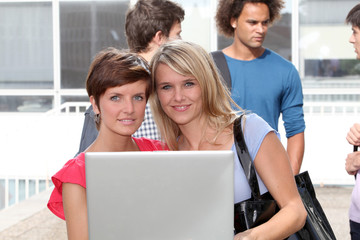 Students at college campus with laptop computer