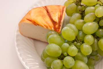 Goat cheese and grapes on the plate