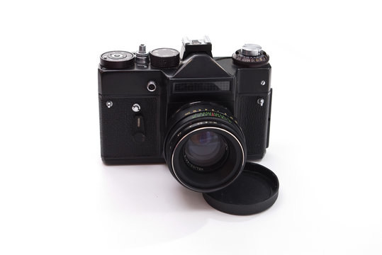 An old film reflex camera isolated on white