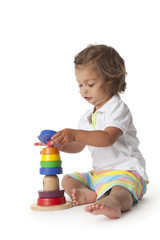 Toddler girl playing with colored bricks