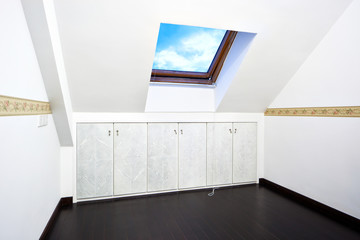 Attic room with roof skylight window