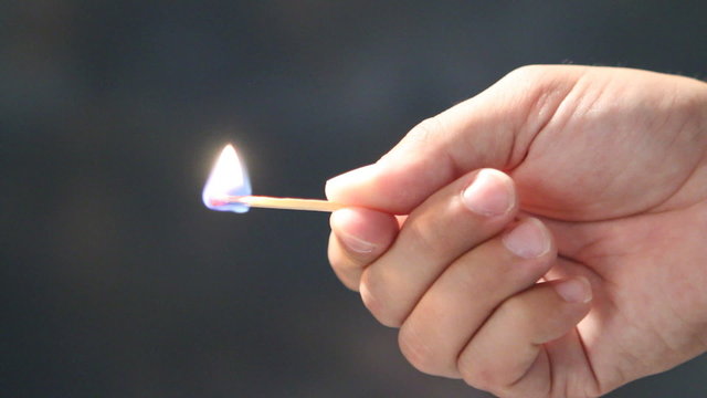 Holding Burning Match