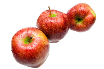 Three juicy apples lays on white background
