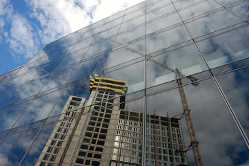 Reflection of building site on glass facade