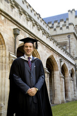 A portrait of a young European man in a graduation gown.