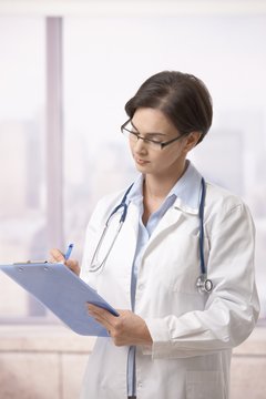 Female doctor doing paperwork in hospital