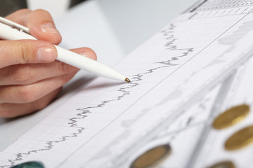 woman&rsquo;s hand holding a pen