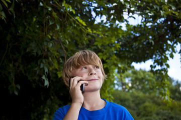 young boy talking on a cell phone.