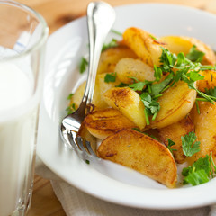 Roasted potatoes with herbs and a glass of buttermilk