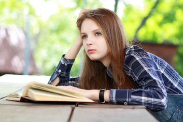 Fototapeta premium Girl with a book outdoors