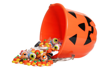 child halloween pumpkin bucket spilling candy - 25553896
