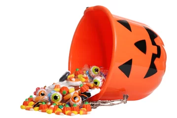 Fotobehang child halloween pumpkin bucket spilling candy © Michael Gray
