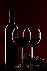 glas of red wine and bottle