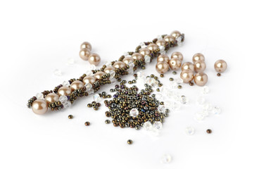 Brown pearl bracelet beading tools isolated on white background