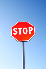 Stop sign for traffic against blue sky