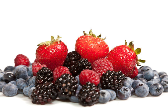 Composition of ripe black and red raspberries, strawberries and