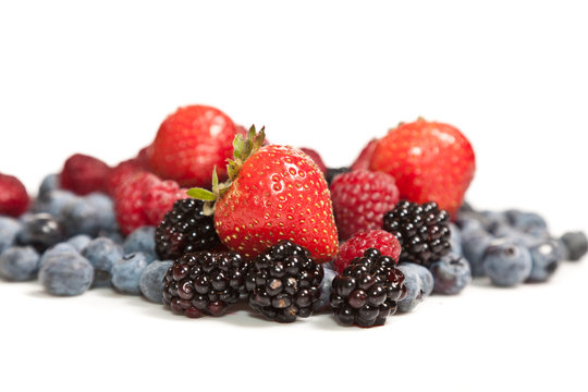 Composition of ripe black and red raspberries, strawberries and