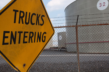 Trucks Entering Sign & Oil Tank Farm