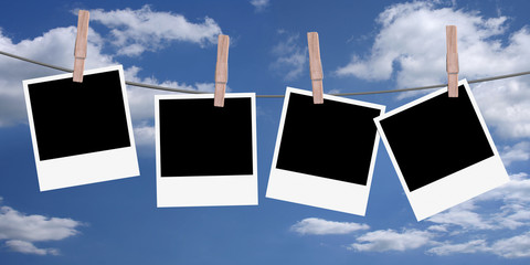 4 polaroids hanging on a rope