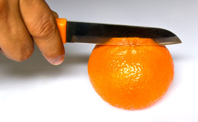 chopping orange on white background