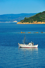 Fototapeta na wymiar Fishing trawler among Greek islands