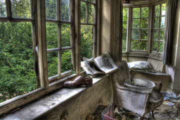 HDR photo of shoes and book in window of old derelict house