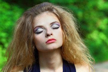 Naklejka premium The beautiful girl with an unusual make-up on the nature