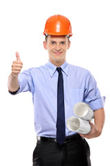 Construction worker holding blueprints and giving thumbs-up agai
