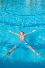 teenager swims in pool