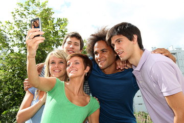 Group of friends taking picture with mobile phone