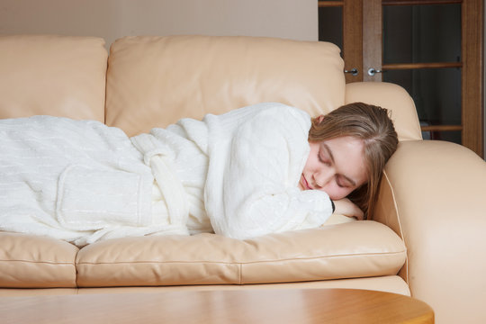 Young Woman Asleep On Sofa