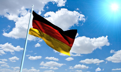 German Flag in front of vivid, sunny, cloudy sky