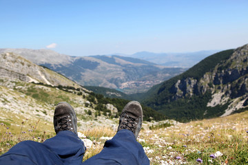 Fototapeta na wymiar Person Relax on Top of a Mountain Against Great Panorama