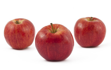 Three ripe red apples on white
