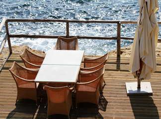 Table and chairs on a terrace overlooking the island Crete