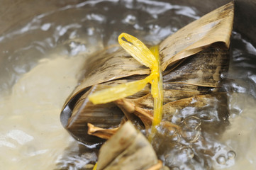 Single meat dumpling in boiling pot