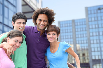 Group of friends standing in front of modern buildings in  town