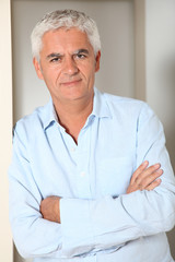 Portrait of smiling senior man at home