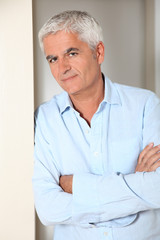 Portrait of smiling senior man at home